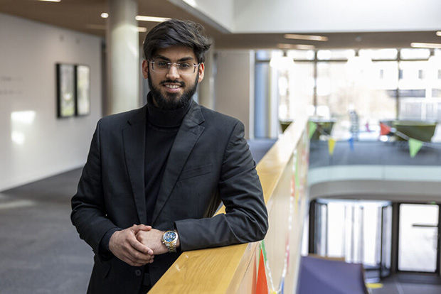 Kent Business School: Students sit and chat on campus grounds